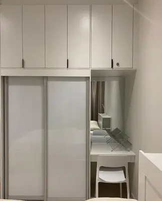 a room with white cabinets and a table and a desk at Lovely Continew Residence 2 Bedrooms - KL in Kuala Lumpur