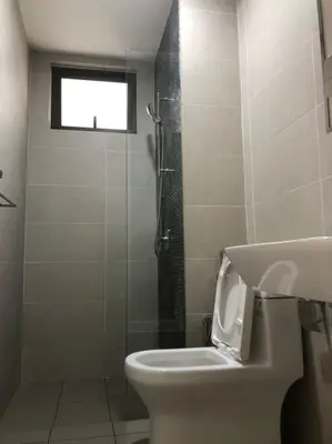 a bathroom with a toilet and a shower with a window at Lovely Continew Residence 2 Bedrooms - KL in Kuala Lumpur