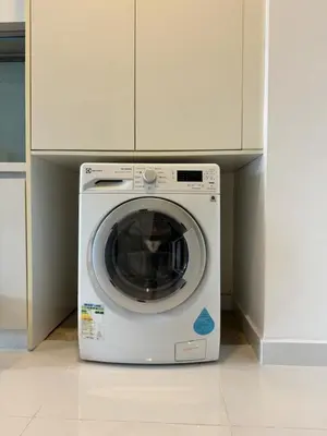 a white washing machine sitting in a kitchen at The Face Platinum Suites KLCC in Kuala Lumpur