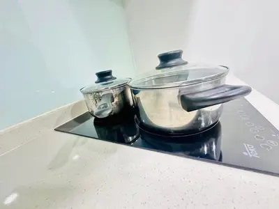 two pots sitting on top of a stove at Velocity Residence at Sunway mall in Kuala Lumpur