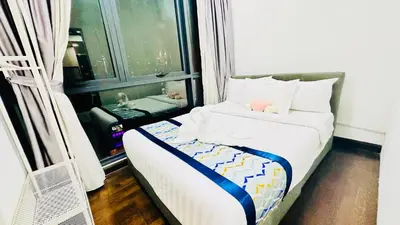 a small bedroom with a bed with a window at Velocity Residence at Sunway mall in Kuala Lumpur