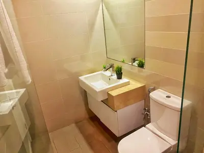 a bathroom with a sink and a toilet and a mirror at Oneiro One Bukit Ceylon in Kuala Lumpur