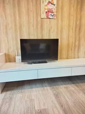 a flat screen tv sitting on top of a white entertainment center at Oneiro One Bukit Ceylon in Kuala Lumpur