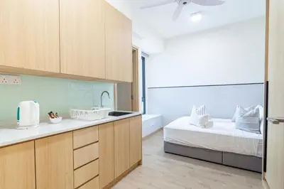 a kitchen with a bed and a sink in a room at Colony @ Kampung Baru by Plush in Kuala Lumpur
