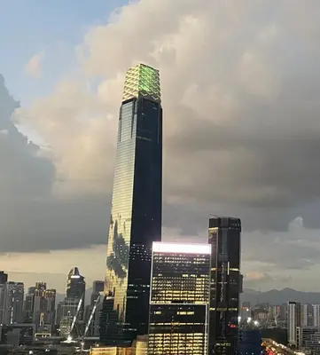 a tall skyscraper with green lights on it in a city at Happy Continew Residence 2 Bedrooms - TRX KL in Kuala Lumpur