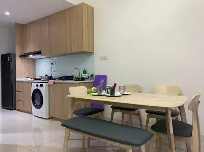 a kitchen with a table and chairs in a kitchen at Happy Continew Residence 2 Bedrooms - TRX KL in Kuala Lumpur