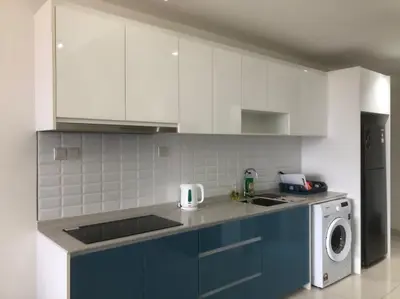 a kitchen with blue and white cabinets and a dishwasher at Happy Continew Residence 2 Bedrooms - TRX KL in Kuala Lumpur
