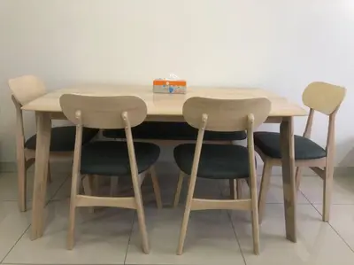 a wooden table with four chairs around it at Happy Continew Residence 2 Bedrooms - TRX KL in Kuala Lumpur