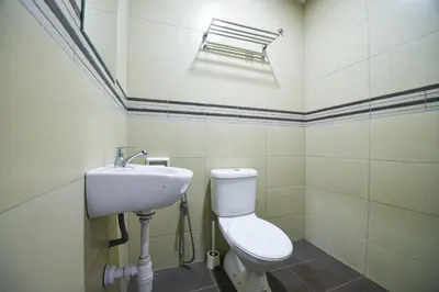 a bathroom with a toilet and a sink at Meta Hotel in Kuala Lumpur