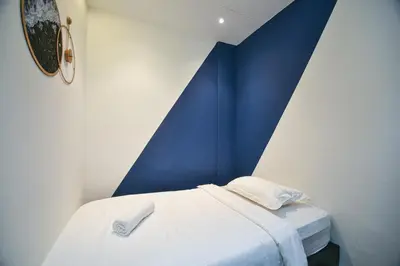 a bedroom with a blue and white wall at Meta Hotel in Kuala Lumpur