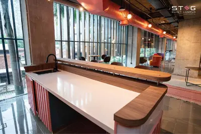 a counter in a restaurant with a bench at STEG Kuala Lumpur in Kuala Lumpur