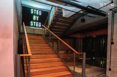 a set of stairs in a building with a sign at STEG Kuala Lumpur in Kuala Lumpur
