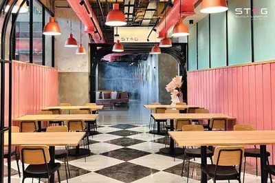 a cafeteria with tables and chairs and a checkered floor at STEG Kuala Lumpur in Kuala Lumpur
