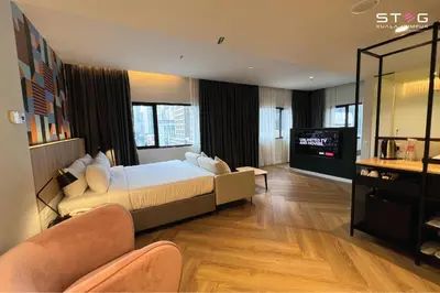 a hotel room with a bed and a television at STEG Kuala Lumpur in Kuala Lumpur