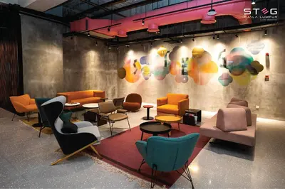a group of chairs and tables in a room at STEG Kuala Lumpur in Kuala Lumpur