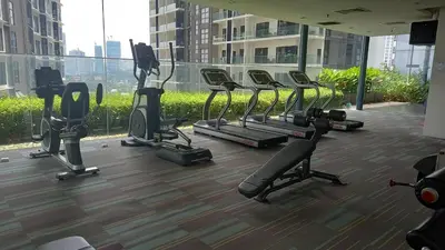 a gym with tread machines in a building at CUSHY APARTMENT at KLCC in Kuala Lumpur