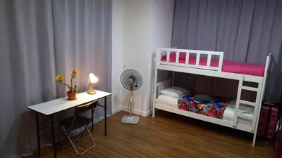a small room with a bunk bed and a desk at CUSHY APARTMENT at KLCC in Kuala Lumpur