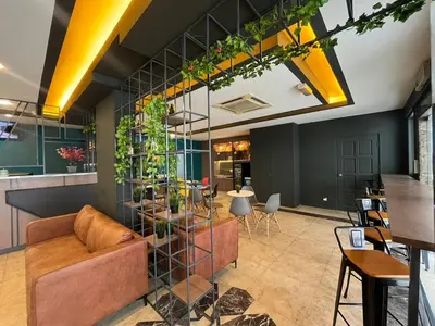 a living room with a couch and a table with plants at Smile Hotel Titiwangsa Pekeliling Sentul in Kuala Lumpur