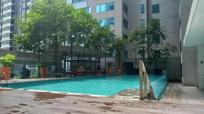 a swimming pool in the middle of a building at Summer Suites Klcc by Malenehom in Kuala Lumpur