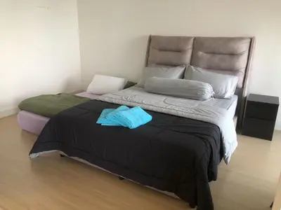 a bedroom with a large bed with two towels on it at Lucky Continew Residence 1 Bedroom - TRX KL in Kuala Lumpur