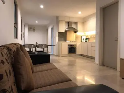 a living room with a couch and a kitchen at Gorgeous Fairlane 2 Bedrooms - Bukit Bintang KL in Kuala Lumpur