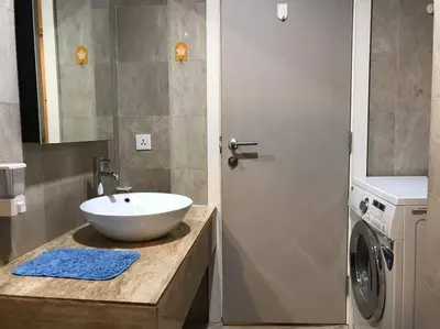 a bathroom with a sink and a washing machine at Gorgeous Fairlane 2 Bedrooms - Bukit Bintang KL in Kuala Lumpur