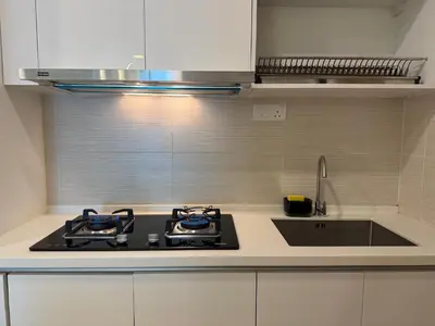 a kitchen with a stove and a sink at Legasi Kampung Baru KL Homestay in Kuala Lumpur