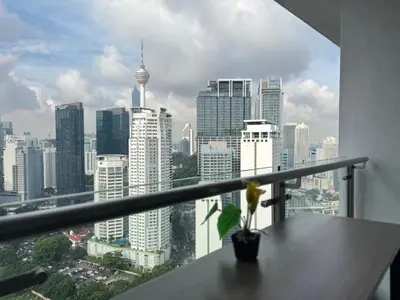 a view of a city skyline from a balcony at Legasi Kampung Baru KL Homestay in Kuala Lumpur