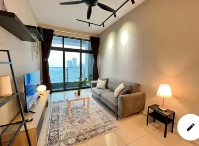 a living room with a couch and a ceiling fan at Legasi Kampung Baru KL Homestay in Kuala Lumpur