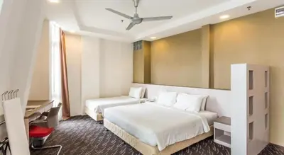 a hotel room with two beds and a window at Palette KL Sentral Station Formerly Scott Hotel in Kuala Lumpur