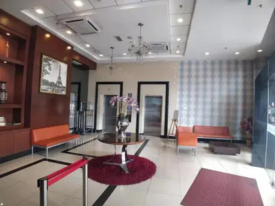 a lobby with a vase of flowers on a table at Palette KL Sentral Station Formerly Scott Hotel in Kuala Lumpur