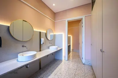 a bathroom with two sinks and two mirrors at Scarletz Suites KLCC by MyKey in Kuala Lumpur