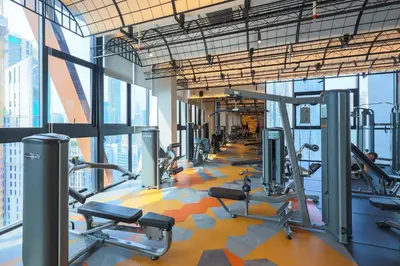 a gym with a lot of treadmills and machines at Scarletz Suites KLCC by MyKey in Kuala Lumpur