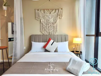 a bedroom with a bed with white and red pillows at Scarletz Suites KLCC by MyKey in Kuala Lumpur