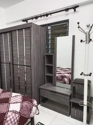 a bedroom with a bed and a mirror at Homestay D'Zara in Kuala Lumpur