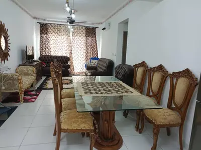 a dining room with a glass table and chairs at Homestay D'Zara in Kuala Lumpur