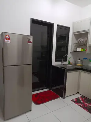 a kitchen with a refrigerator and a sink at Homestay D'Zara in Kuala Lumpur