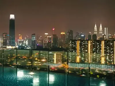 a view of a city skyline at night at Homestay D'Zara in Kuala Lumpur