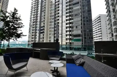 a patio with chairs and a couch on a balcony at Stylish & Cozy 2BR Apt at Arte Plus, FREE Parking in Kuala Lumpur