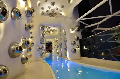 a room with a bunch of silver balls on the wall at Stylish & Cozy 2BR Apt at Arte Plus, FREE Parking in Kuala Lumpur