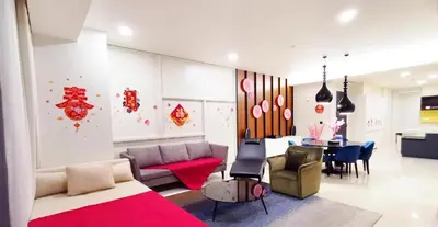 a living room with a couch and a table at Tropicana The Residences KLCC By Luxury Suites in Kuala Lumpur