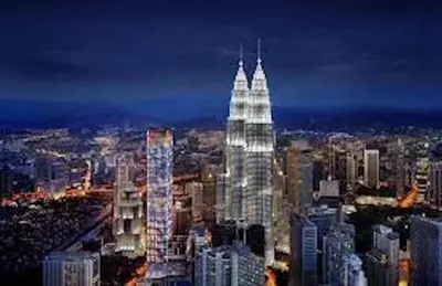 a lit up skyscraper in a city at night at Tropicana The Residences KLCC By Luxury Suites in Kuala Lumpur