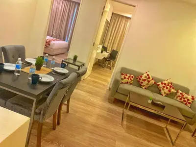 a living room with a table and a couch at Lila Suites One Bukit Ceylon in Kuala Lumpur