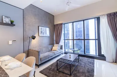 a living room with a couch and a large window at Mcity at Jalan Ampang in Kuala Lumpur