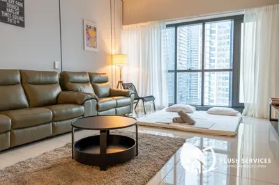 a living room with a couch and a table at Mcity at Jalan Ampang in Kuala Lumpur