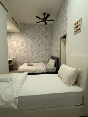 a bedroom with two beds and a ceiling fan at Mcity at Jalan Ampang in Kuala Lumpur
