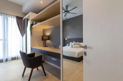 a bedroom with a bed and a chair in a room at Mcity at Jalan Ampang in Kuala Lumpur
