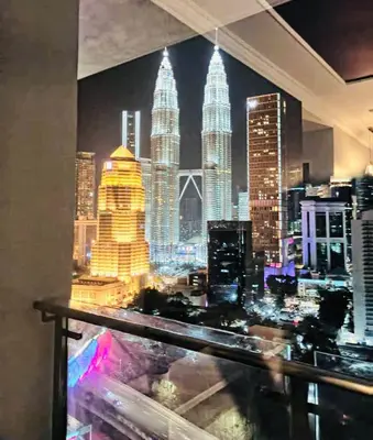 a view of the kuala lumpur city skyline at night at 3 Bedrooms Short Stays Condo at KLCC in Kuala Lumpur