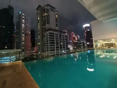 a swimming pool on the roof of a building at night at City Home Suites Kuala Lumpur City Centre in Kuala Lumpur