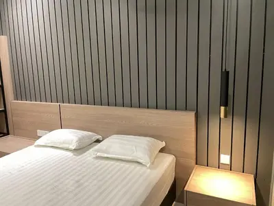 a bedroom with a bed with white sheets at Legasi Kampung Bharu by Tulip in Kuala Lumpur